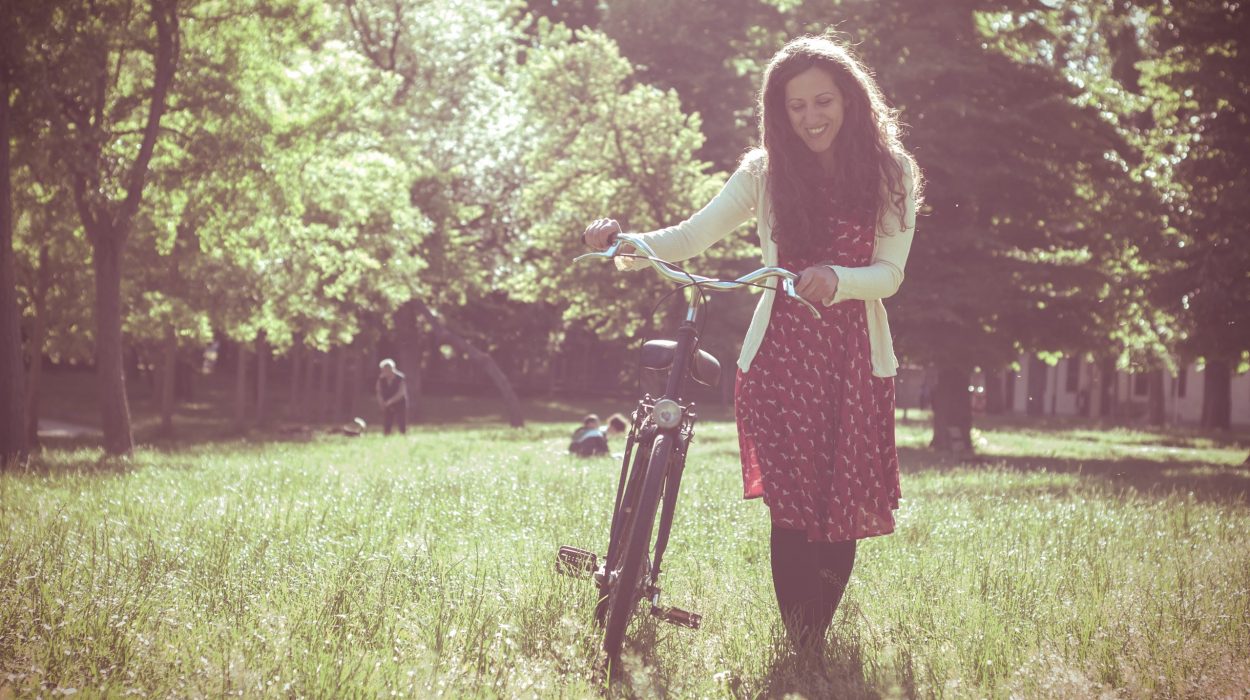 vintage eastern hipster woman with bike in the park